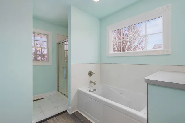 a bathroom with a bathtub and a shower