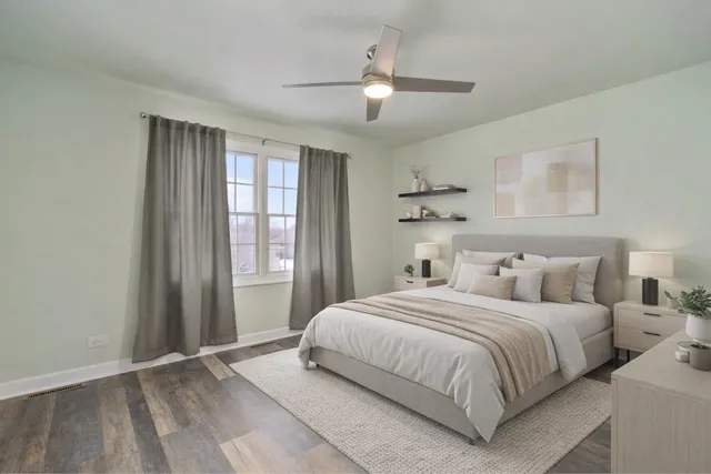 a bedroom with a large bed and a chandelier