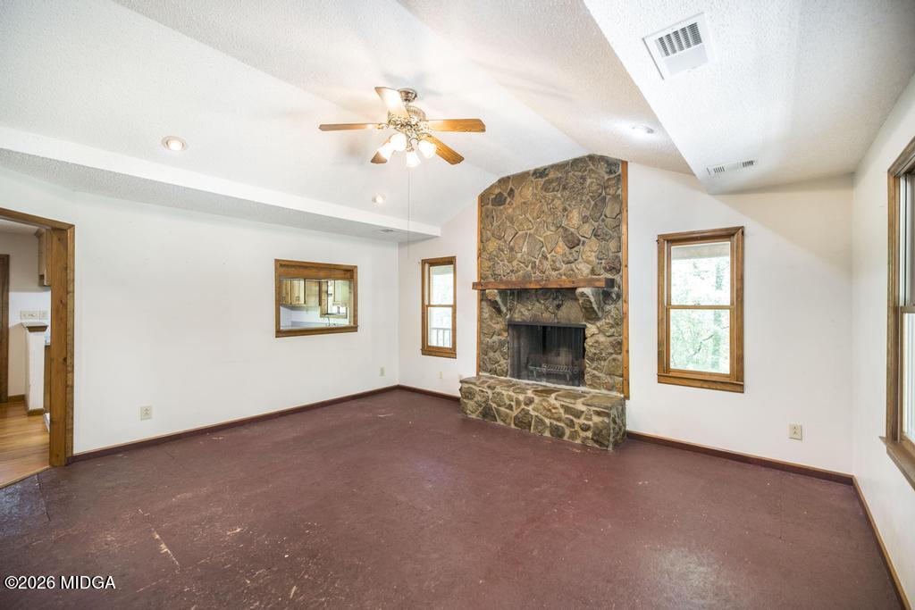 194 Delone Road Byron, GA 31008 - Photo 12 of 49 an empty room with windows and fireplace