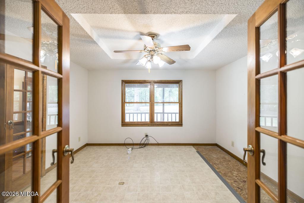 194 Delone Road Byron, GA 31008 - Photo 13 of 49 an empty room with windows and chandelier fan