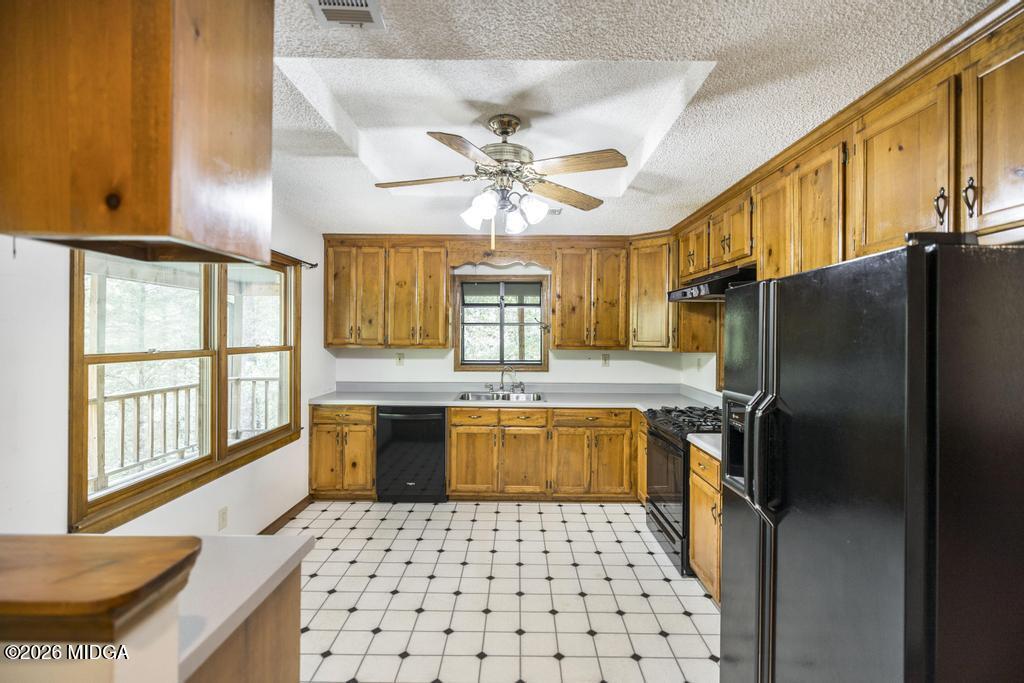 194 Delone Road Byron, GA 31008 - Photo 16 of 49 a kitchen with a sink refrigerator and microwave