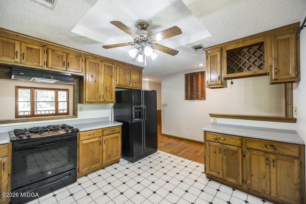 194 Delone Road Byron, GA 31008 - Photo 18 of 49 a kitchen with stainless steel appliances granite countertop a stove a sink dishwasher and a refrigerator with wooden cabinets