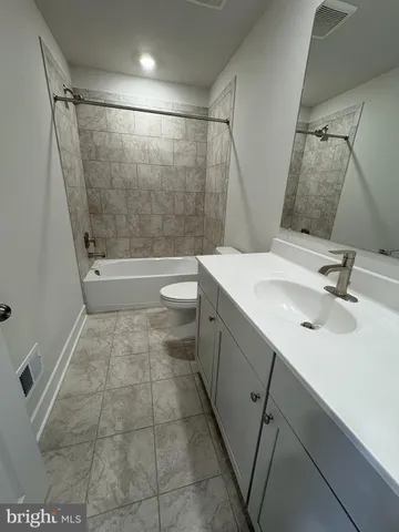 a bathroom with a sink a toilet and a shower