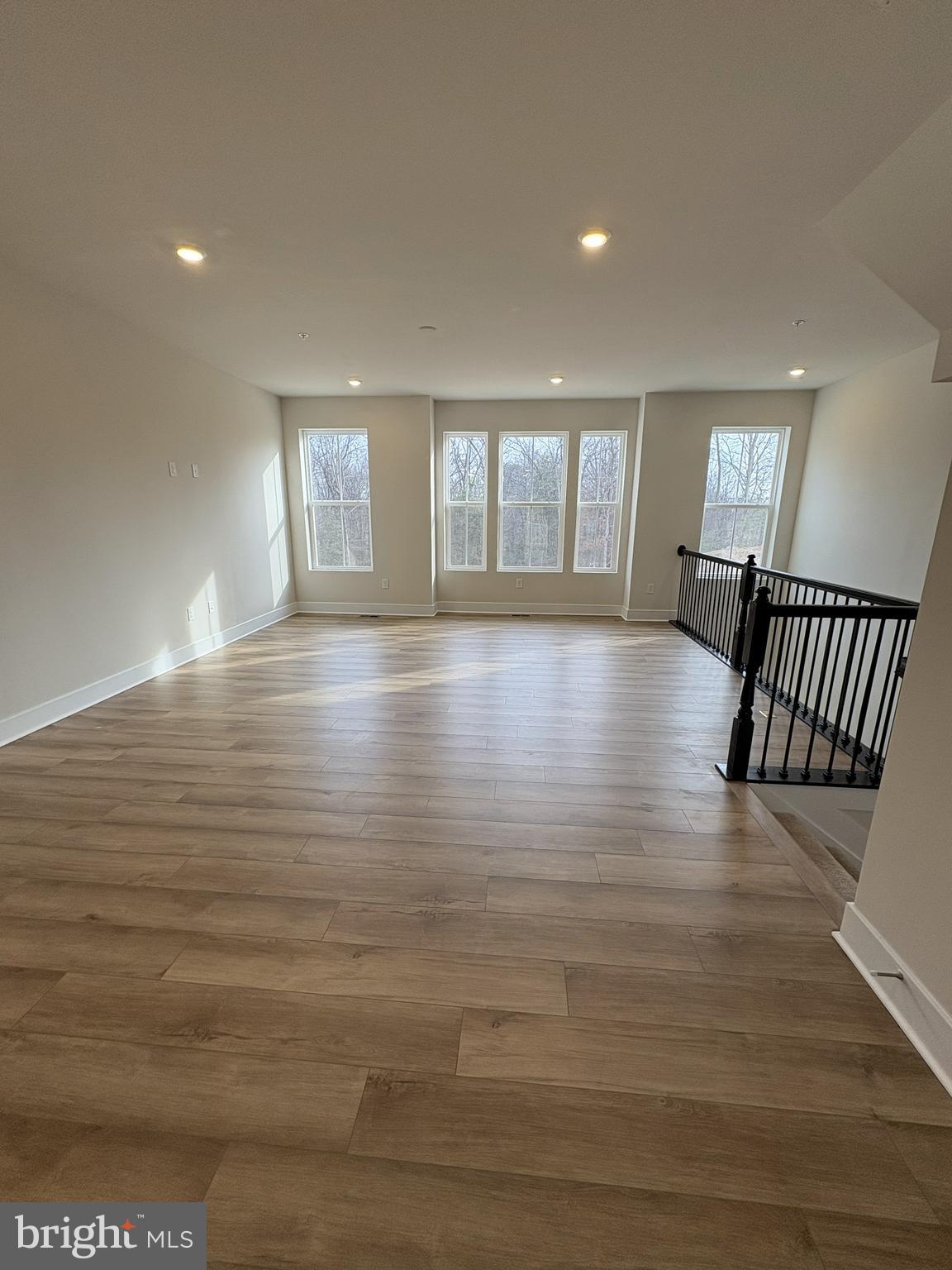 7448 Cornerstone Way Laurel, MD 20707 - Photo 5 of 13 a view of an empty room with wooden floor and a window