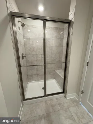 a bathroom with a glass shower door