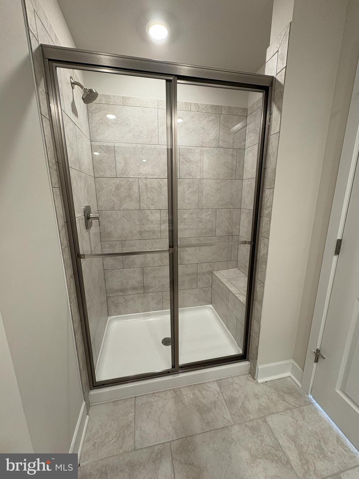 7448 Cornerstone Way Laurel, MD 20707 - Photo 9 of 13 a bathroom with a glass shower door