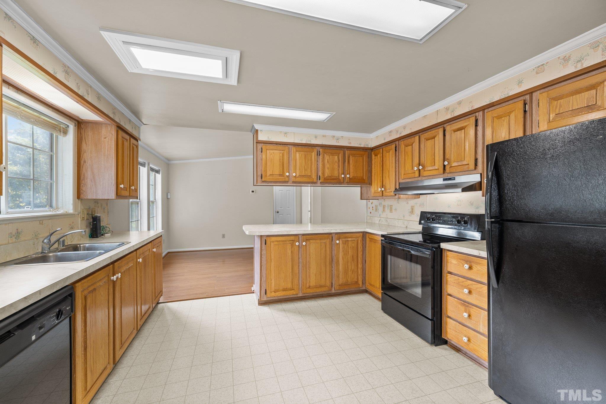 4505 Guess Road Rougemont, NC 27572 - Photo 11 of 33 a kitchen with stainless steel appliances granite countertop a refrigerator sink stove microwave and cabinets