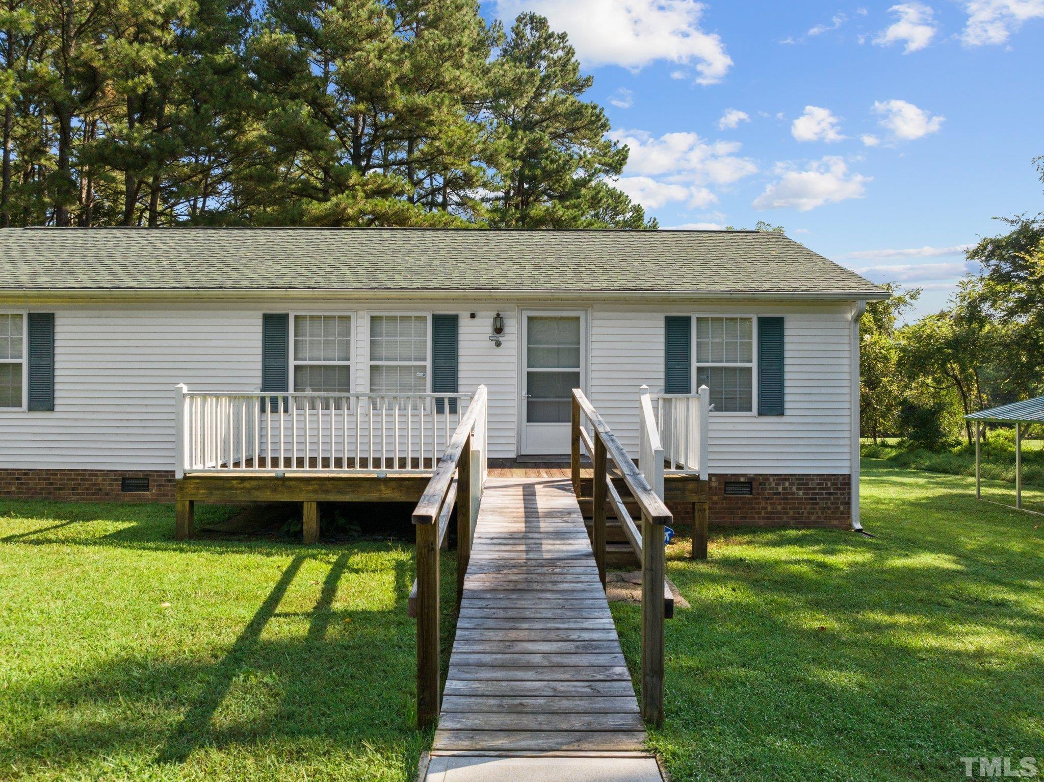 4505 Guess Road Rougemont, NC 27572 - Photo 2 of 33 a view of a house with a backyard and a wooden deck