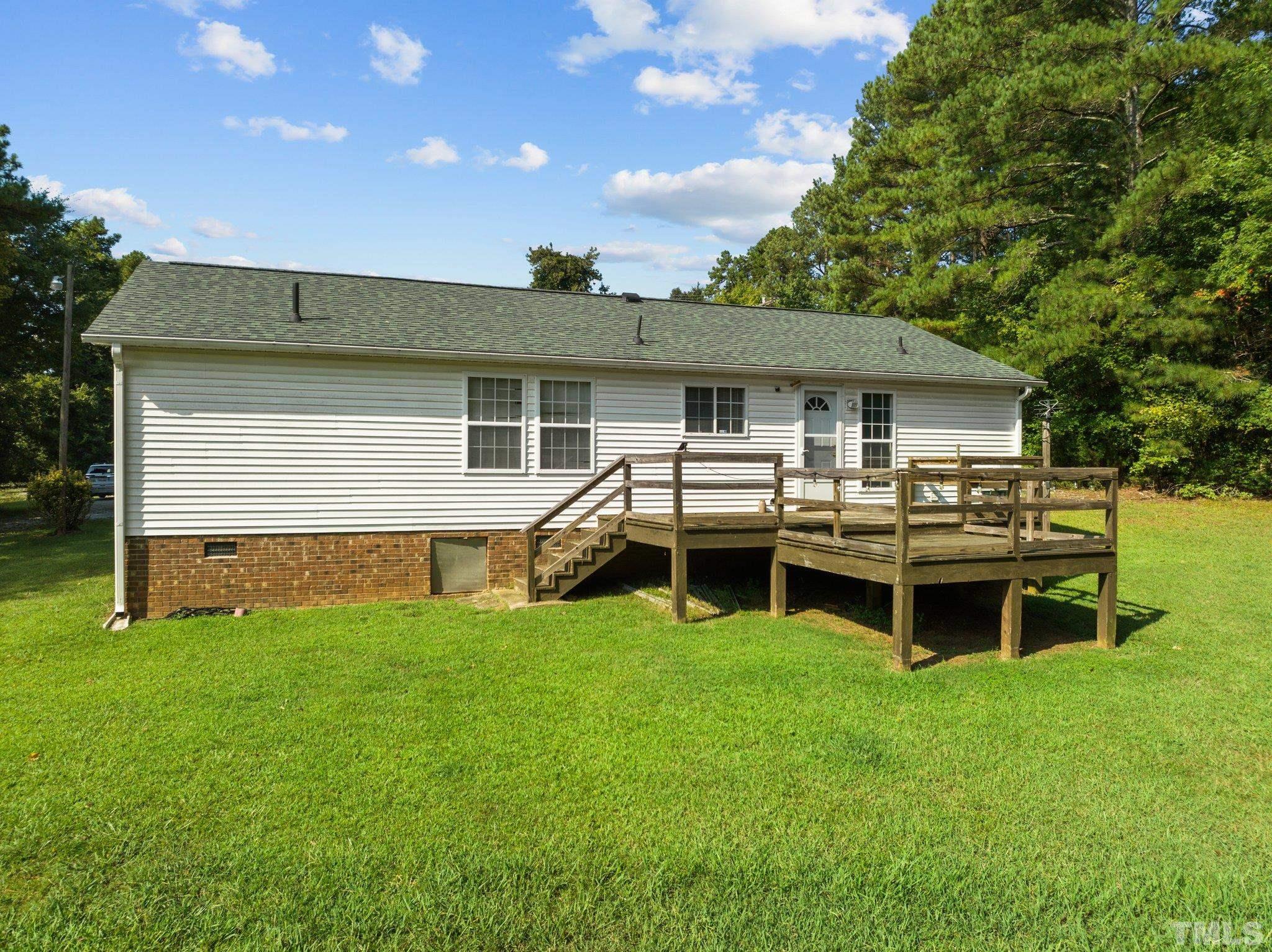4505 Guess Road Rougemont, NC 27572 - Photo 25 of 33 a view of a house with a backyard and a patio