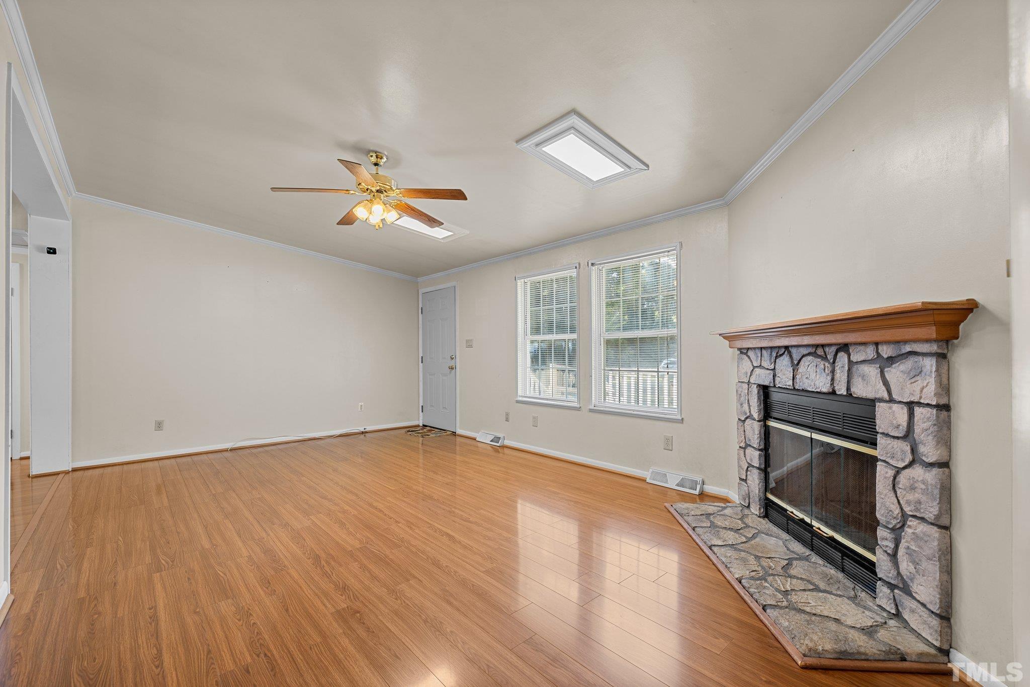 4505 Guess Road Rougemont, NC 27572 - Photo 7 of 33 wooden floor in an empty room with a fireplace and a window