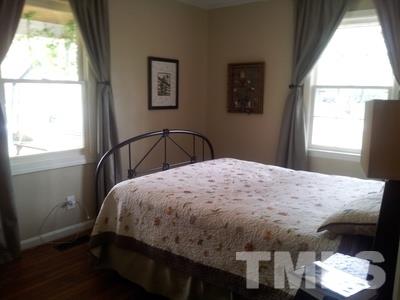501 Mial Street Raleigh, NC 27608 - Photo 4 of 6 a bedroom with a bed and a window