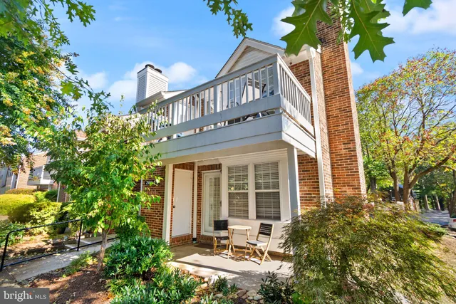 a front view of a house with a yard and fountain in middle