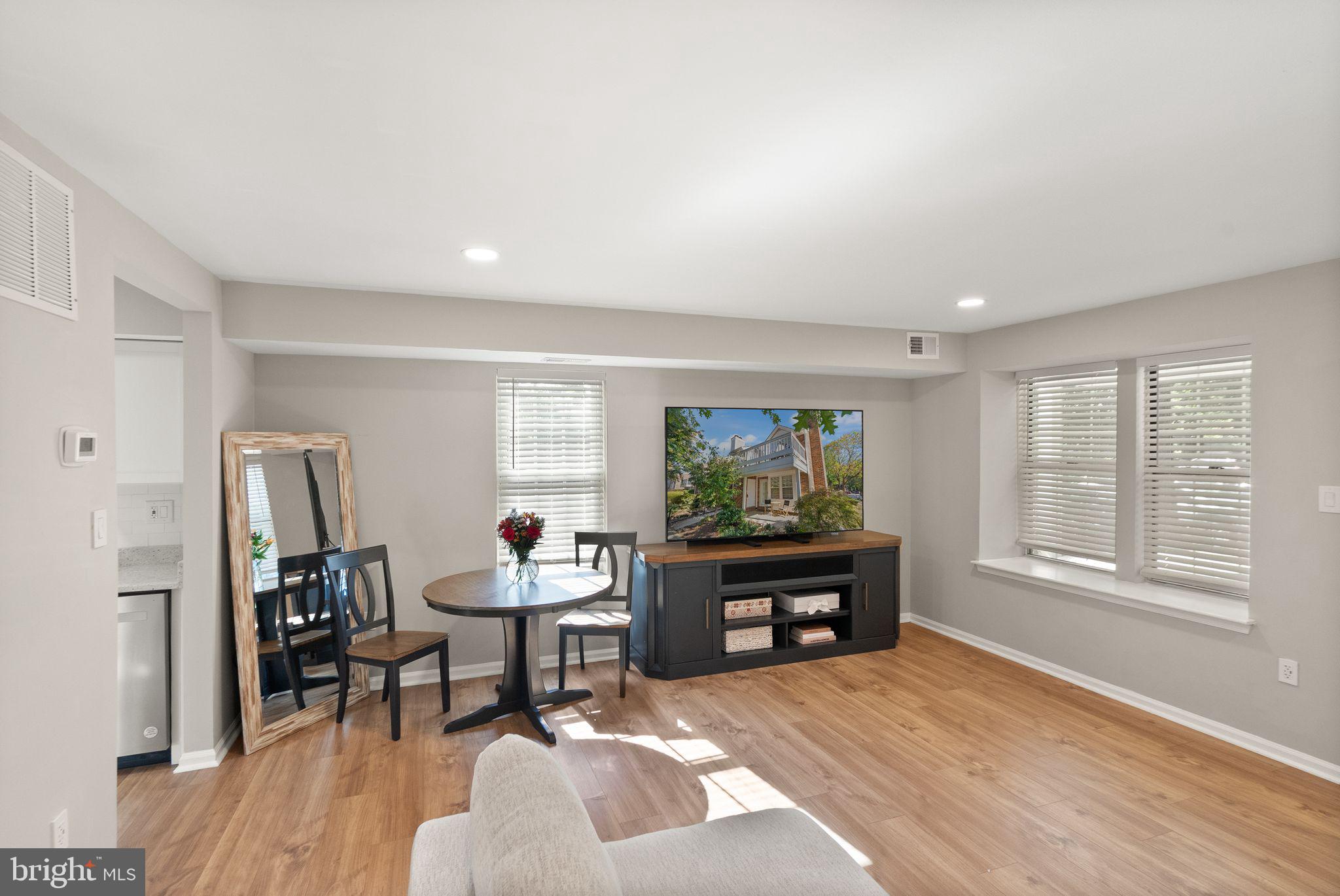 2592 South Arlington Mill Drive, Unit 7 Arlington, VA 22206 - Photo 11 of 44 a living room with furniture a fireplace and a flat screen tv