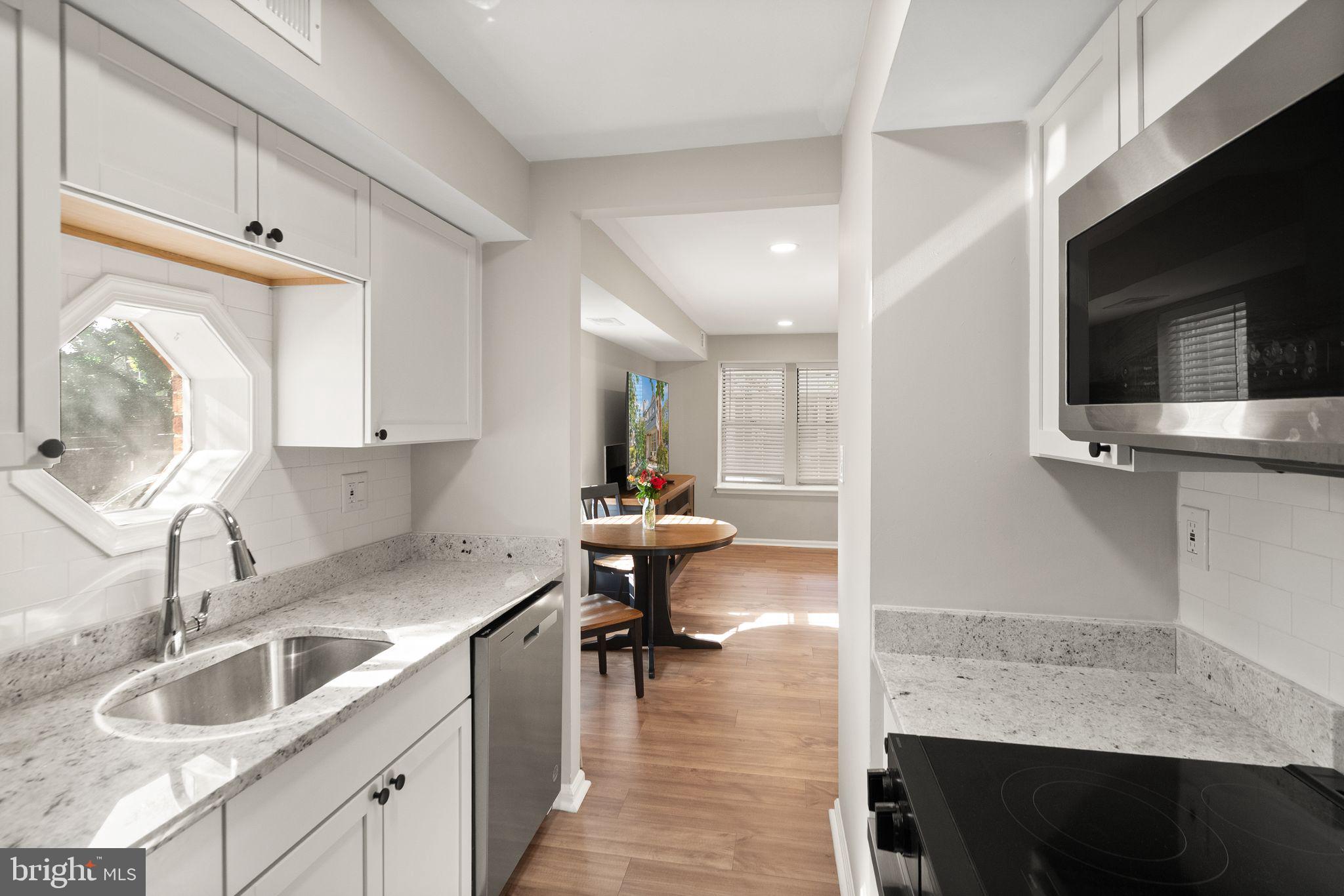 2592 South Arlington Mill Drive, Unit 7 Arlington, VA 22206 - Photo 15 of 44 a kitchen with a sink cabinets and window