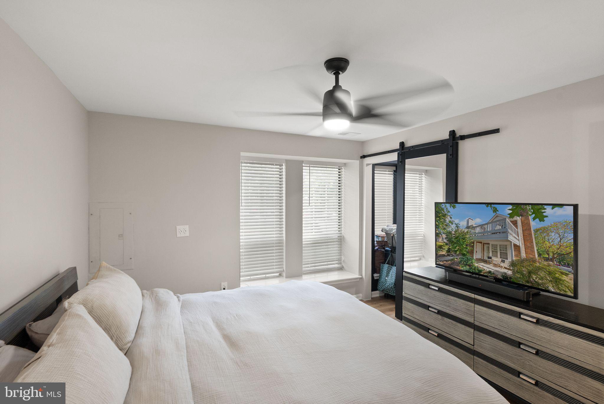 2592 South Arlington Mill Drive, Unit 7 Arlington, VA 22206 - Photo 18 of 44 a bedroom with a bed and a flat screen tv