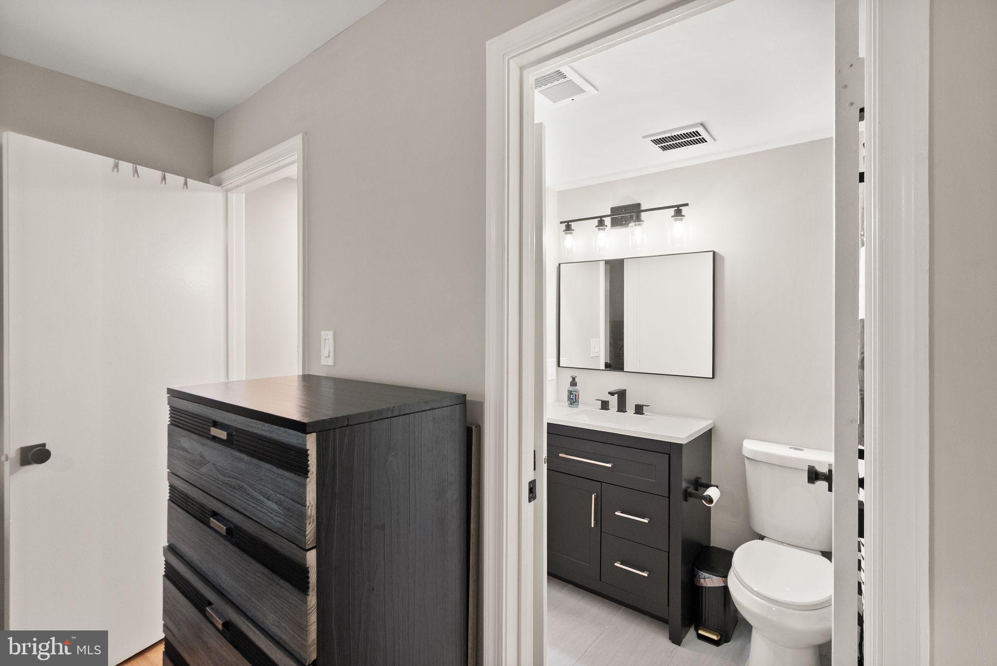 2592 South Arlington Mill Drive, Unit 7 Arlington, VA 22206 - Photo 20 of 44 a bathroom with a toilet sink double vanity and mirror