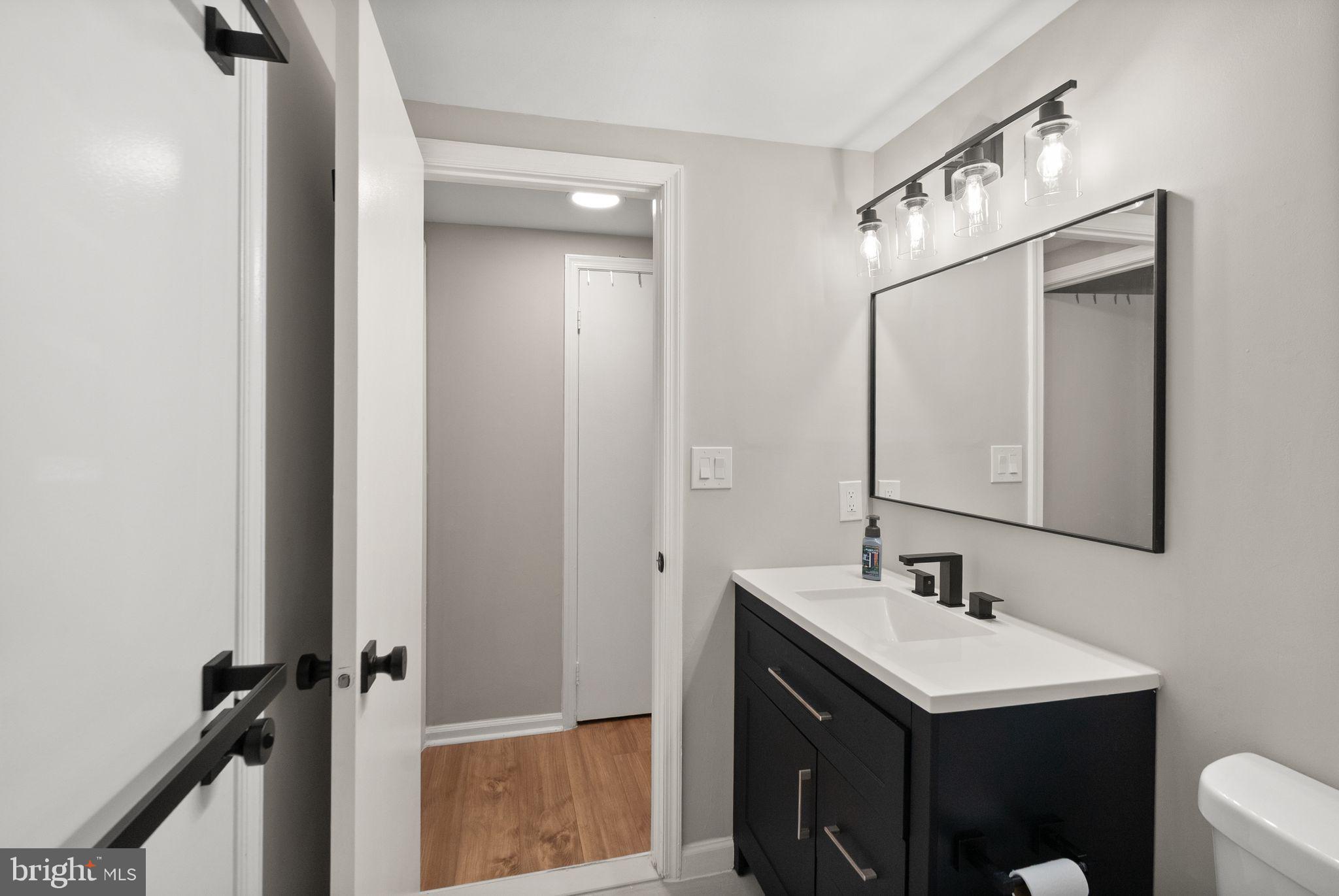 2592 South Arlington Mill Drive, Unit 7 Arlington, VA 22206 - Photo 22 of 44 a bathroom with a sink toilet and mirror