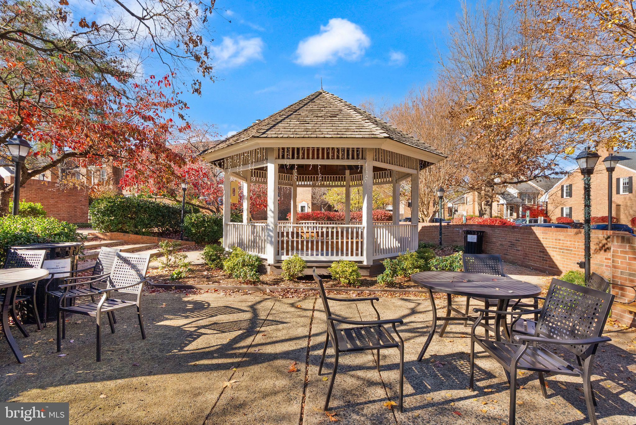 2592 South Arlington Mill Drive, Unit 7 Arlington, VA 22206 - Photo 27 of 44 a view of a patio with table and chairs with wooden floor and fence
