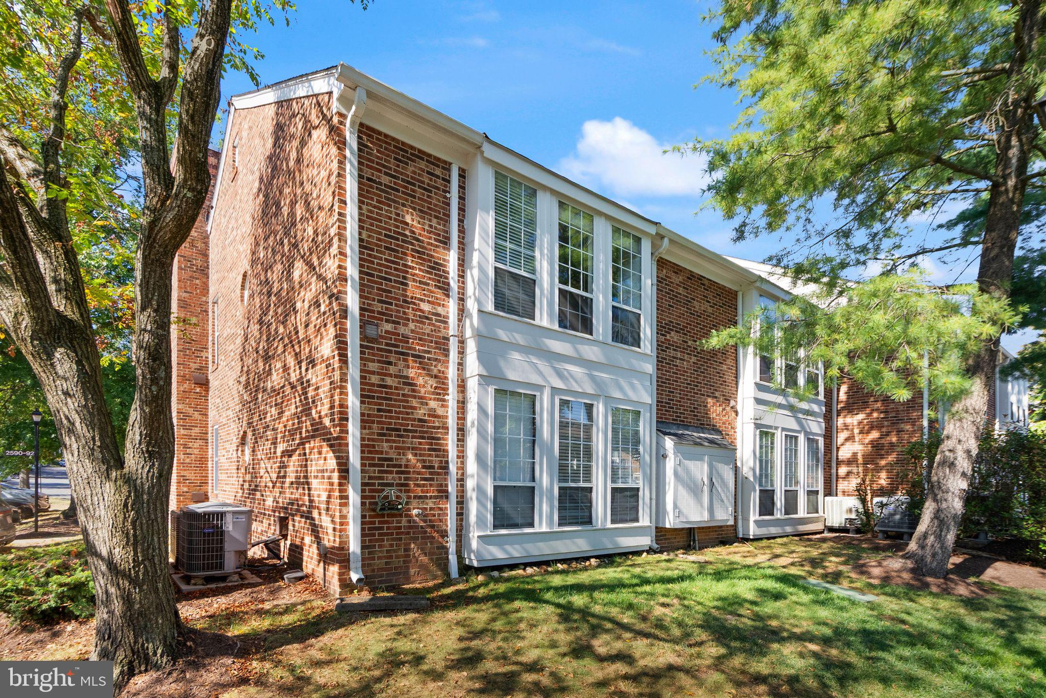2592 South Arlington Mill Drive, Unit 7 Arlington, VA 22206 - Photo 3 of 44 a view of a brick house with a large windows and flower plants