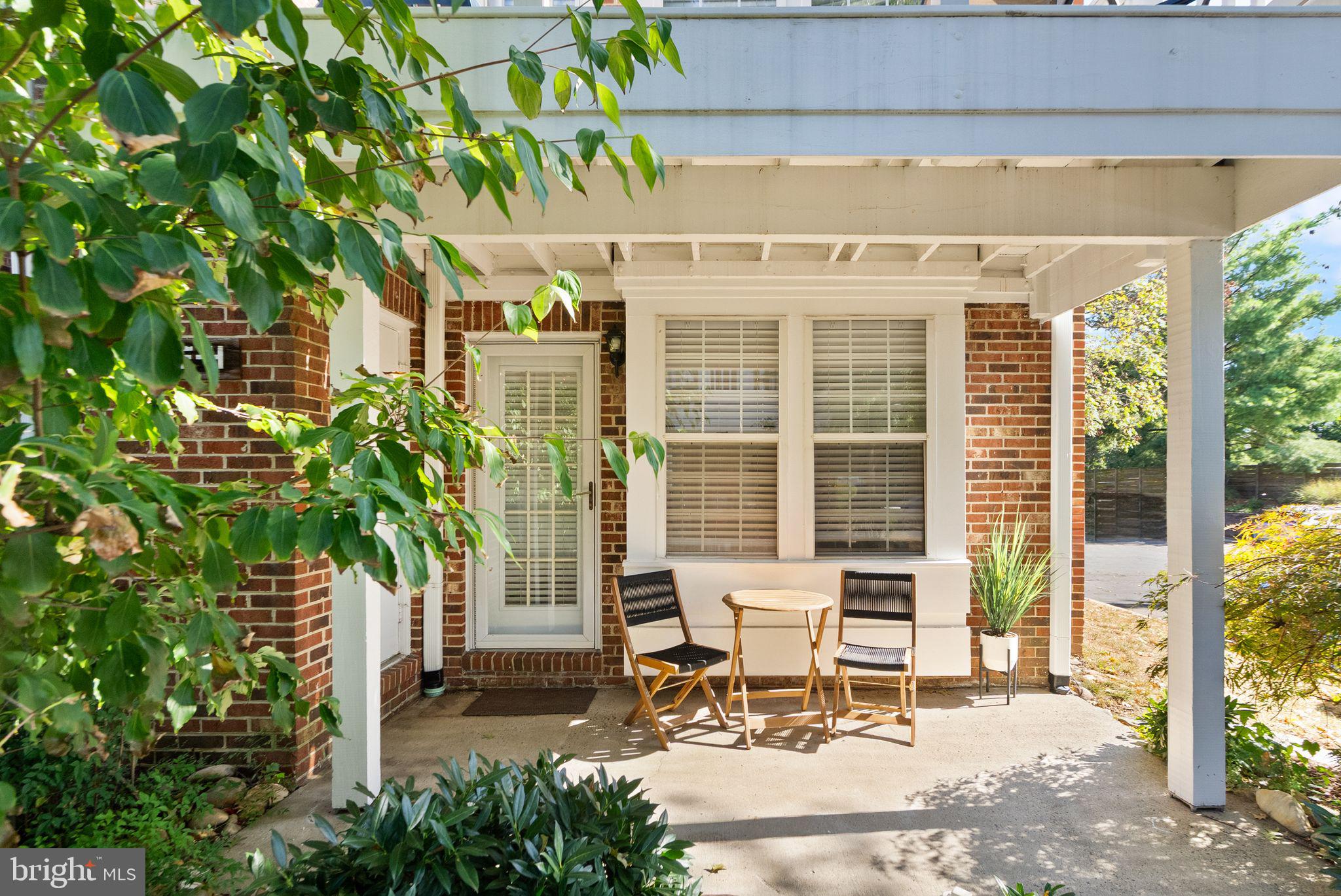 2592 South Arlington Mill Drive, Unit 7 Arlington, VA 22206 - Photo 6 of 44 a patio with table and chairs and potted plants