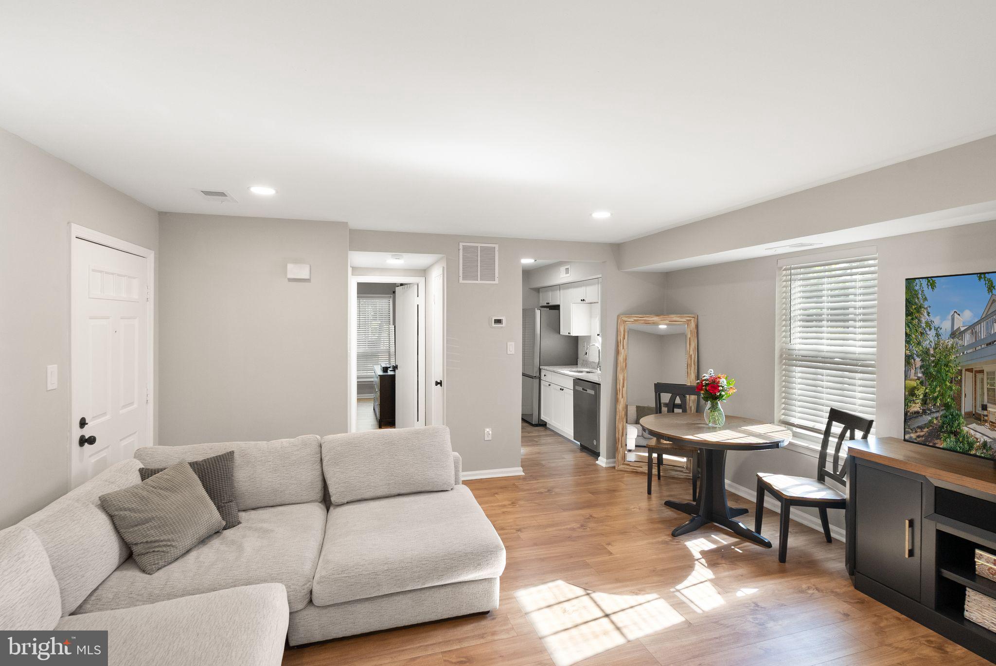 2592 South Arlington Mill Drive, Unit 7 Arlington, VA 22206 - Photo 9 of 44 a living room with furniture and a large window