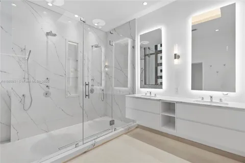 a bathroom with a tub sink and mirror