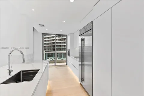 a view of a kitchen with a sink and cabinets