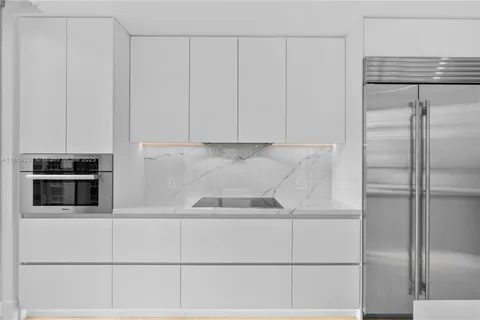 a bedroom with a balcony a bed and a painting on the wall