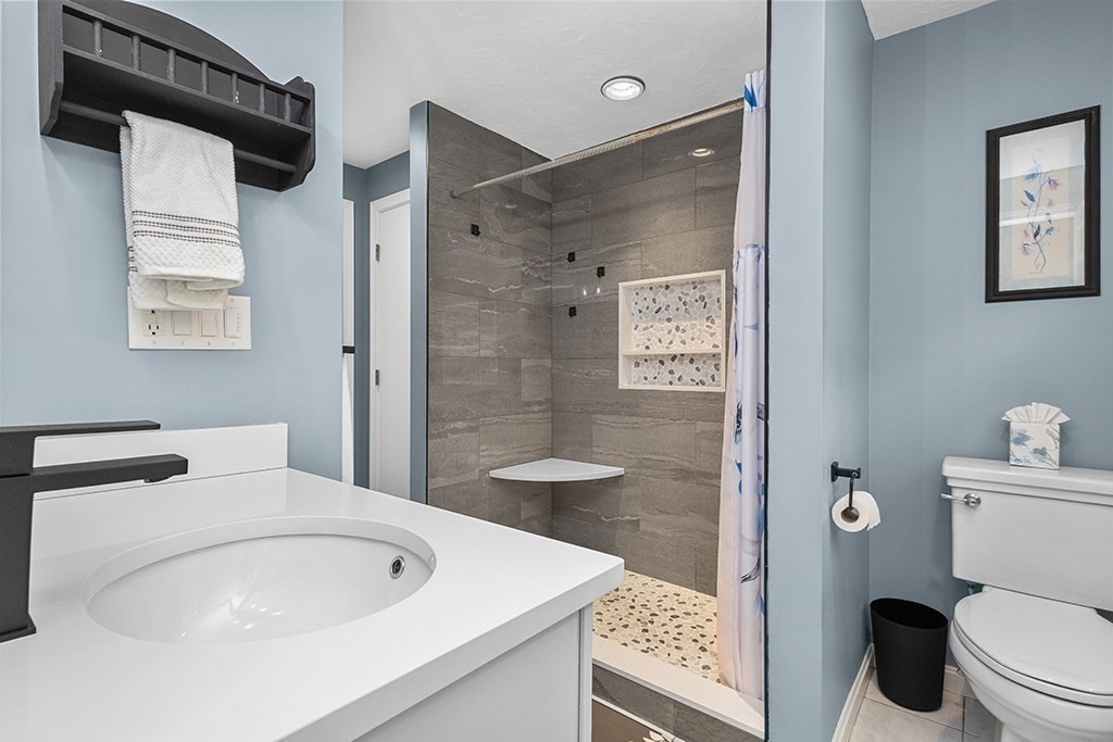 56 Leland Road Norfolk, MA 02056 - Photo 24 of 28 a bathroom with a sink toilet and shower