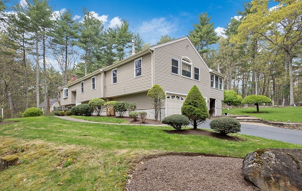 56 Leland Road Norfolk, MA 02056 - Photo 3 of 28 a front view of a house with a yard and trees