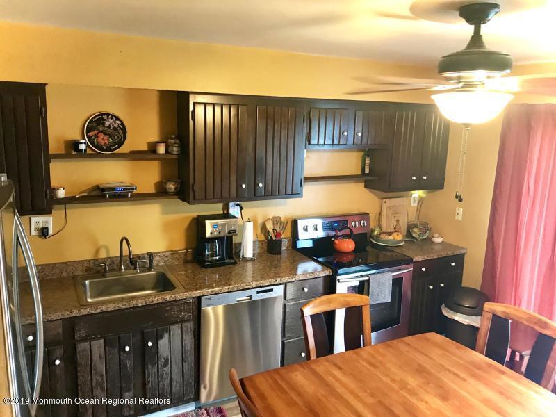 127 B Azalea Court, Unit 1002 Lakewood, NJ 08701 - Photo 4 of 10 a kitchen with a sink and cabinets