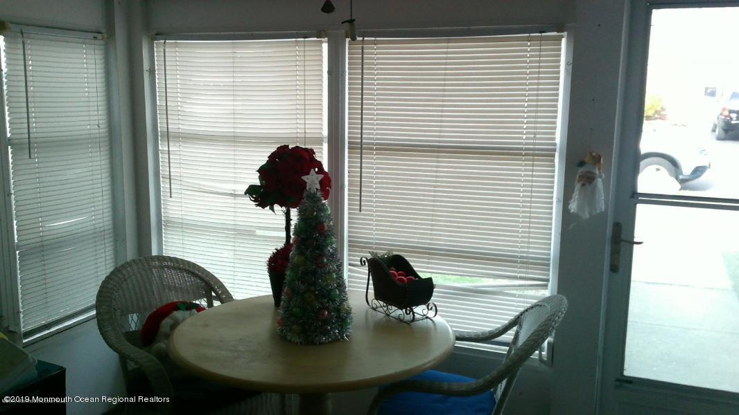 127 B Azalea Court, Unit 1002 Lakewood, NJ 08701 - Photo 8 of 10 a view of a dining room with furniture and window