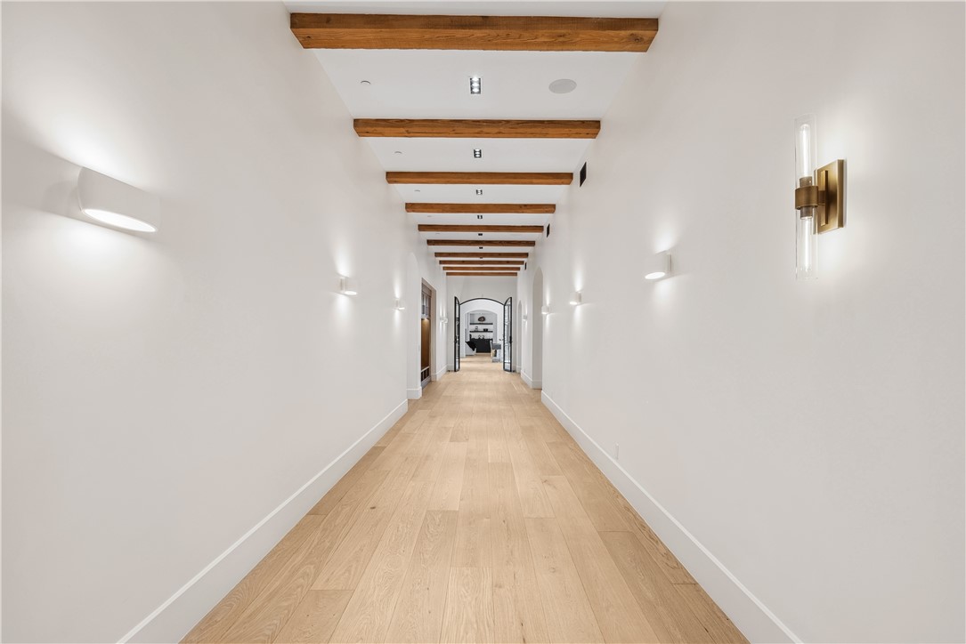 15931 Via De Santa Fe Rancho Santa Fe, CA 92067 - Photo 25 of 50 a view of a hallway with wooden floor and staircase