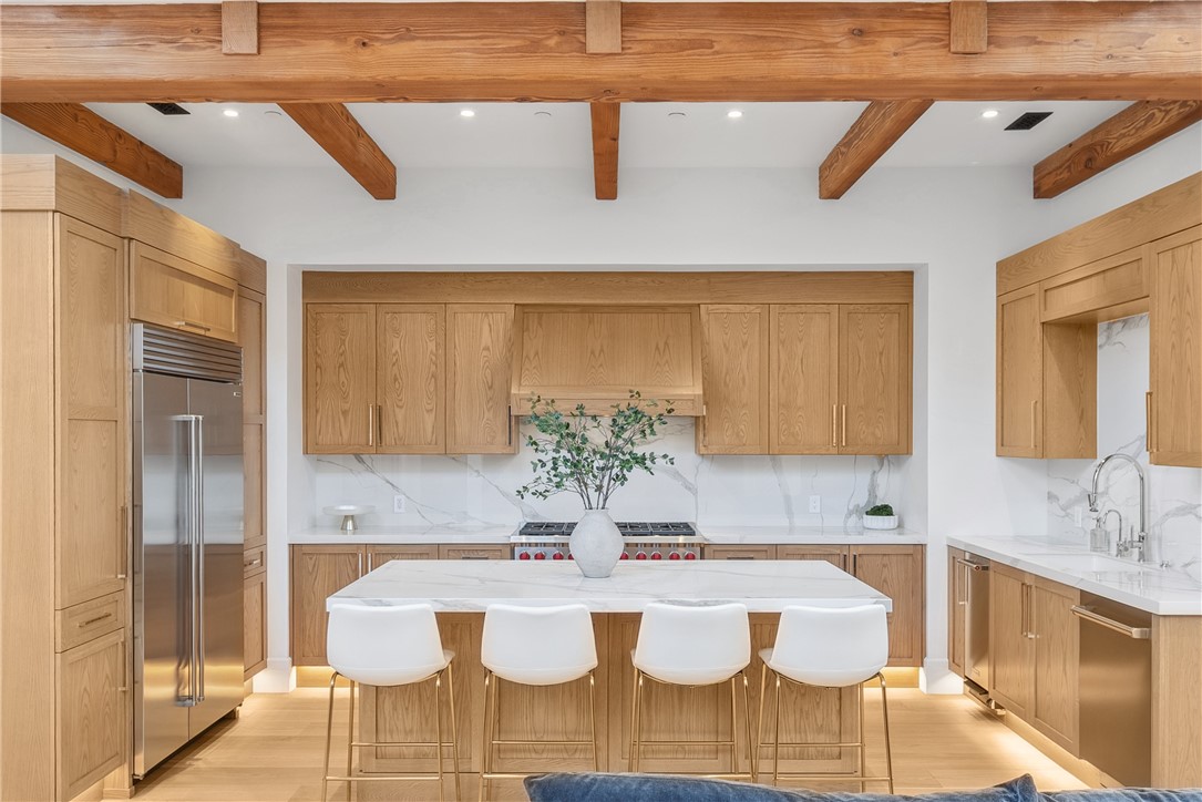 15931 Via De Santa Fe Rancho Santa Fe, CA 92067 - Photo 38 of 50 a white table and chairs in a kitchen