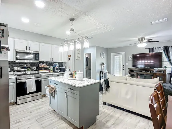 a kitchen with a stove a sink and a refrigerator