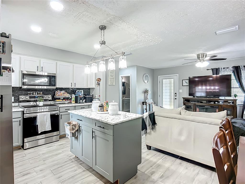8016 Formby Street Riverview, FL 33578 - Photo 11 of 29 a kitchen with a stove a sink and a refrigerator