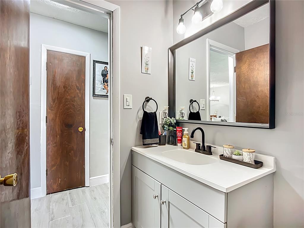 8016 Formby Street Riverview, FL 33578 - Photo 16 of 29 a bathroom with a sink and a mirror