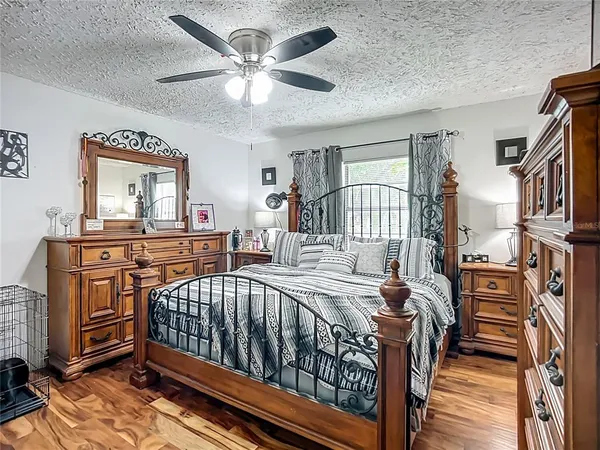 a view of a bedroom with furniture and wooden floor