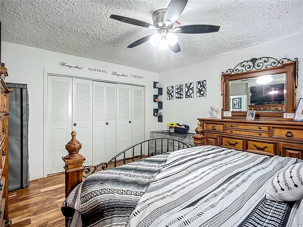8016 Formby Street Riverview, FL 33578 - Photo 21 of 29 a bedroom with a bed and a flat screen tv