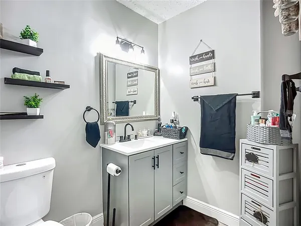 a bathroom with a sink a toilet and mirror