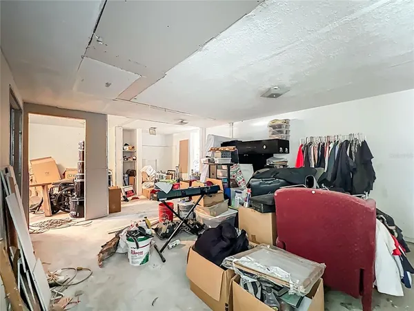 a living room with furniture a floor to ceiling window and a flat screen tv