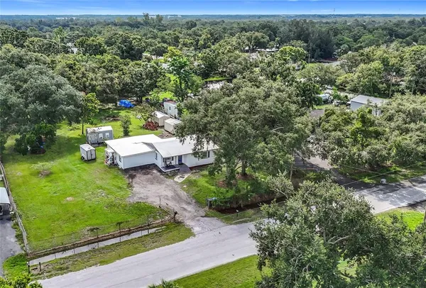 an aerial view of a house with a yard