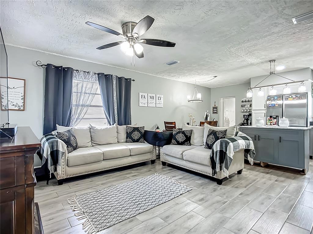 8016 Formby Street Riverview, FL 33578 - Photo 5 of 29 a living room with furniture ceiling fan and a window