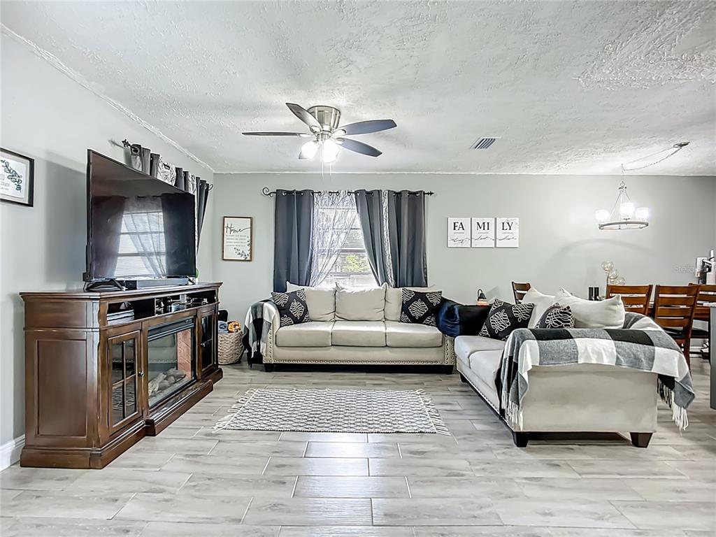 8016 Formby Street Riverview, FL 33578 - Photo 6 of 29 a living room with furniture flat screen tv and window