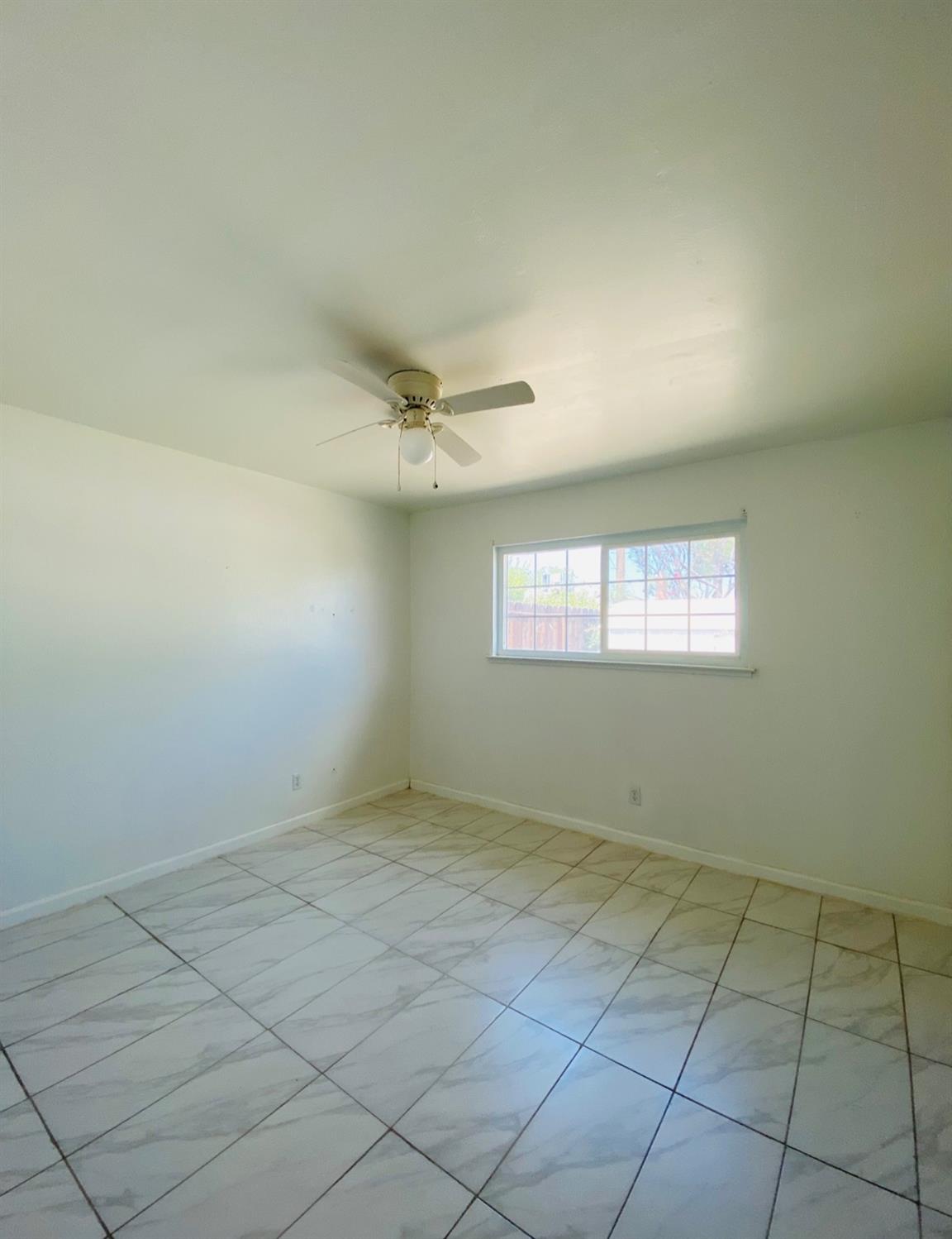 115 Gettysburg Avenue Clovis, CA 93612 - Photo 13 of 17 an empty room with a empty space and windows