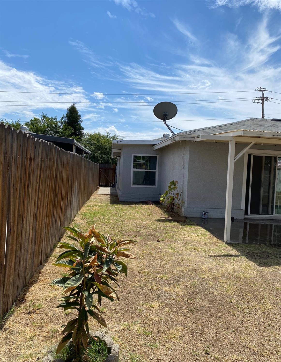 115 Gettysburg Avenue Clovis, CA 93612 - Photo 3 of 17 a bedroom with a bed and a chandelier