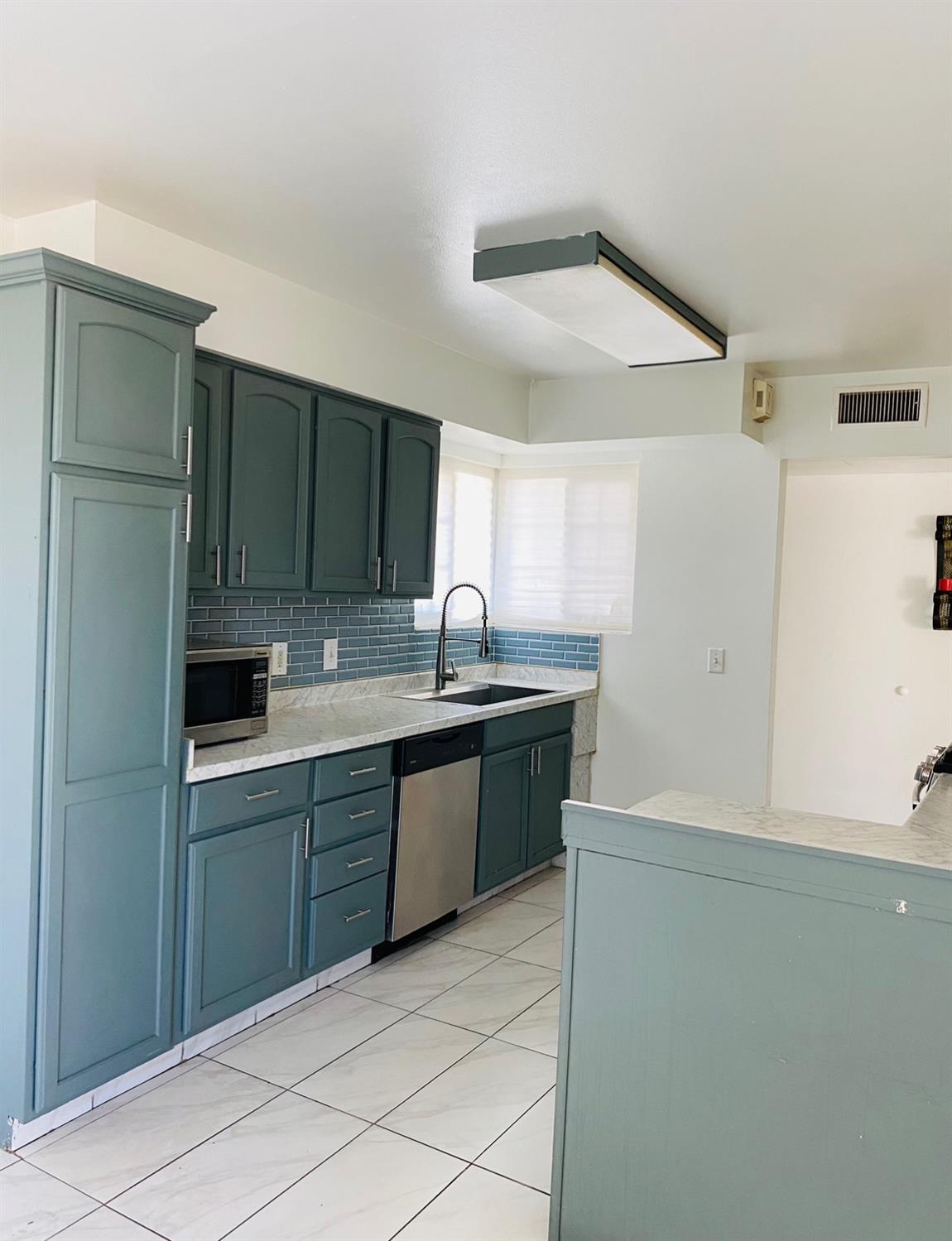 115 Gettysburg Avenue Clovis, CA 93612 - Photo 9 of 17 a kitchen with stainless steel appliances granite countertop a refrigerator and a sink