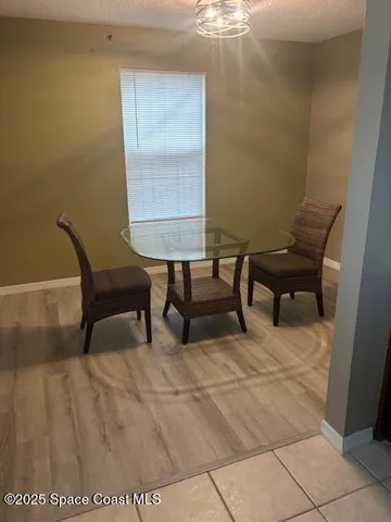 a view of a room with furniture and wooden floor
