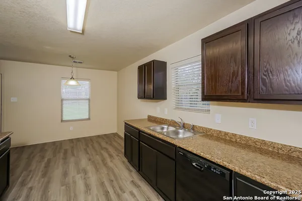 a kitchen with granite countertop wooden cabinets and a stainless steel appliances