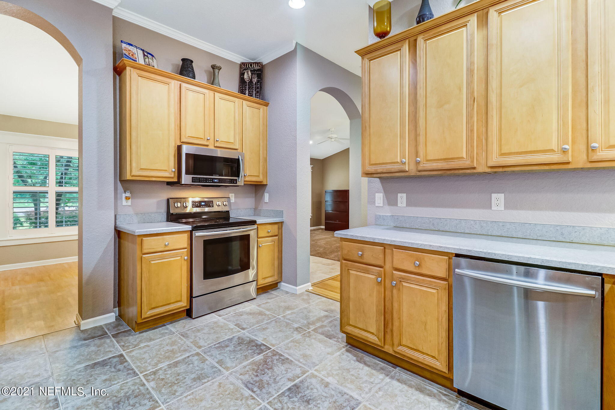 96931 Blackrock Road Yulee, FL 32097 - Photo 12 of 28 a kitchen with stainless steel appliances granite countertop a stove a sink and a microwave